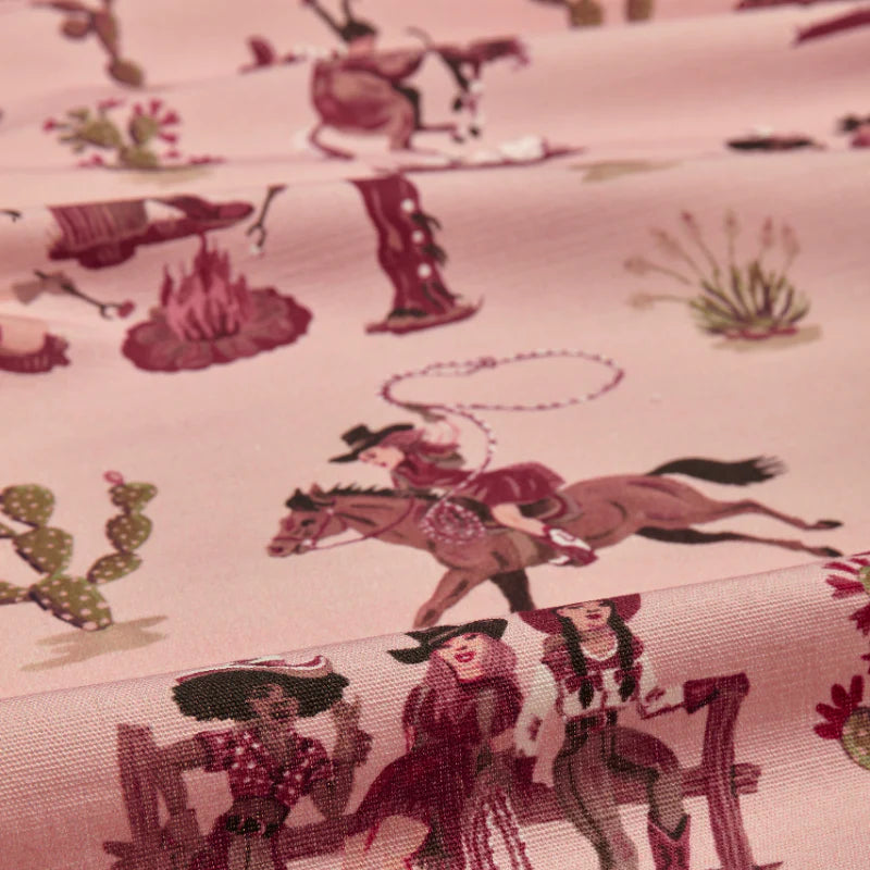 poodle-and-blonde-fabric-linen-cliftonville-cowgirls-pink-based-retro-kitsch-pattern-cowgirls-riding-western-rodeo-pattern-cabin-look-motel-pink