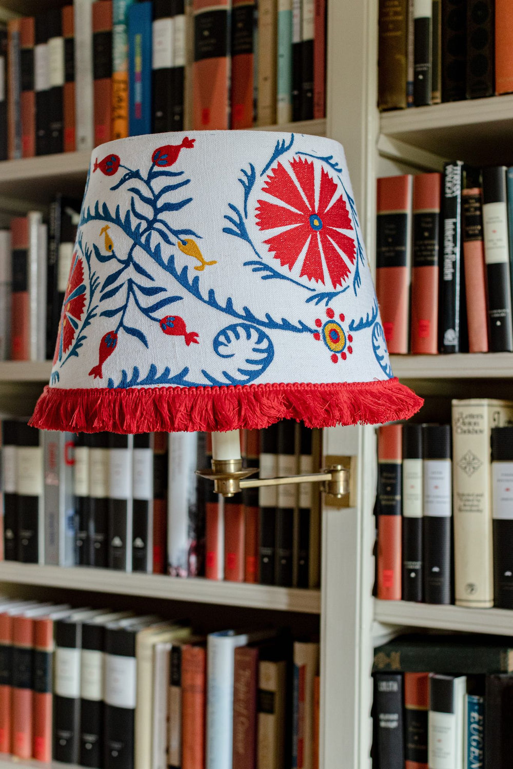 mind the gap embroidered cone lampshade viragos folk design with fringing wall light on book case