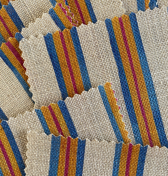 Bethie-tricks-textiles-sandy-stripes-linen-fabric-beach-chair-style-yellow-red-blue-against-cream-linen