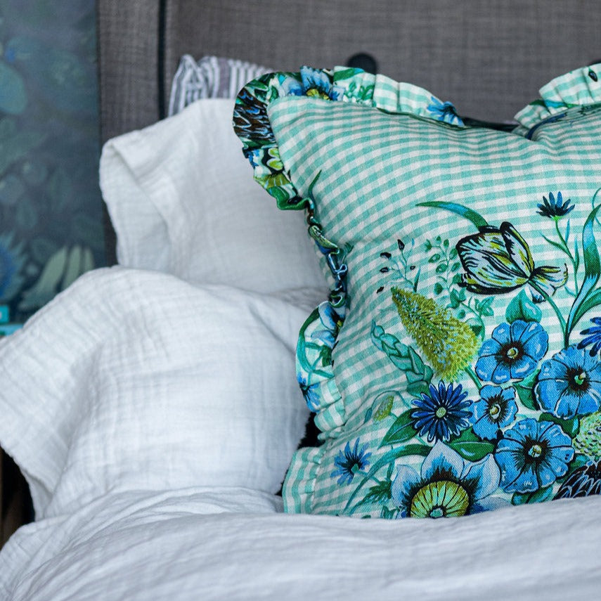 Wear-the-walls-linen-frilled-cushion-in-posy-aqua-gingham-frilled-cushion-large-floral-secondary-print-bold-print-hand-illustrated-lonen-cotton-mix-frill-detail-edges-made-in-england-blue-green-aqua
