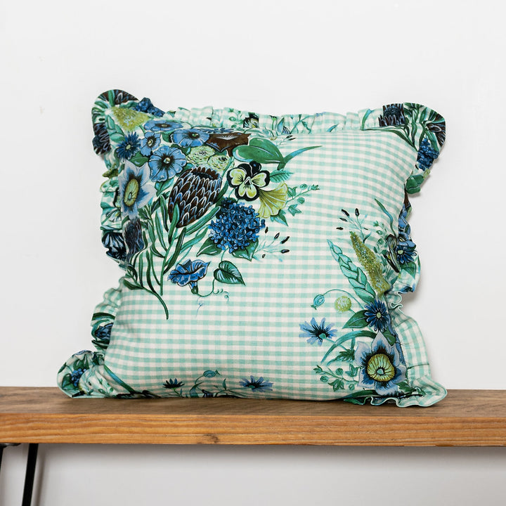 Wear-the-walls-linen-frilled-cushion-in-posy-aqua-gingham-frilled-cushion-large-floral-secondary-print-bold-print-hand-illustrated-lonen-cotton-mix-frill-detail-edges-made-in-england-blue-green-aqua