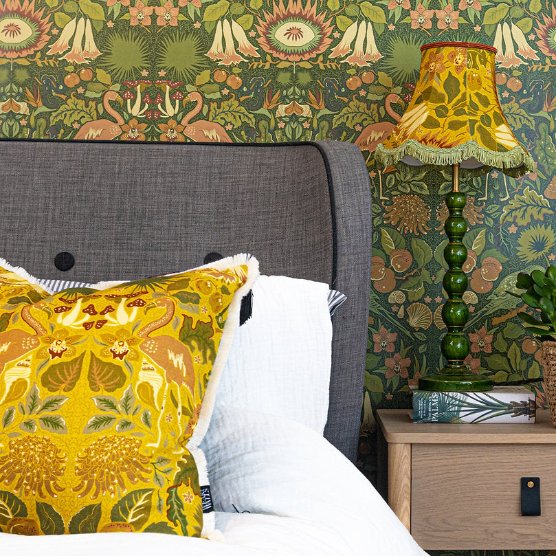 linen-velvet-piped-cushion-in-oasis-marigold-yellow-art-and-crafts-style-pattern-birds-flowers-plants-yellow-red-green-trimmed-cushion-wear-the-walls