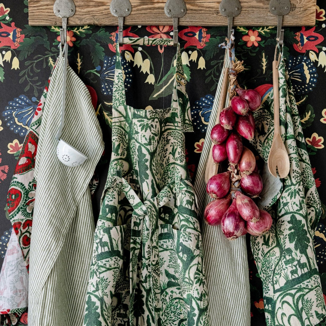Mind-the-gap-enchanted-woodland-linen-printed-wallpaper-scene-apron-stonewashed-wolves-birds-trees-woodland-forest-green-on-cream