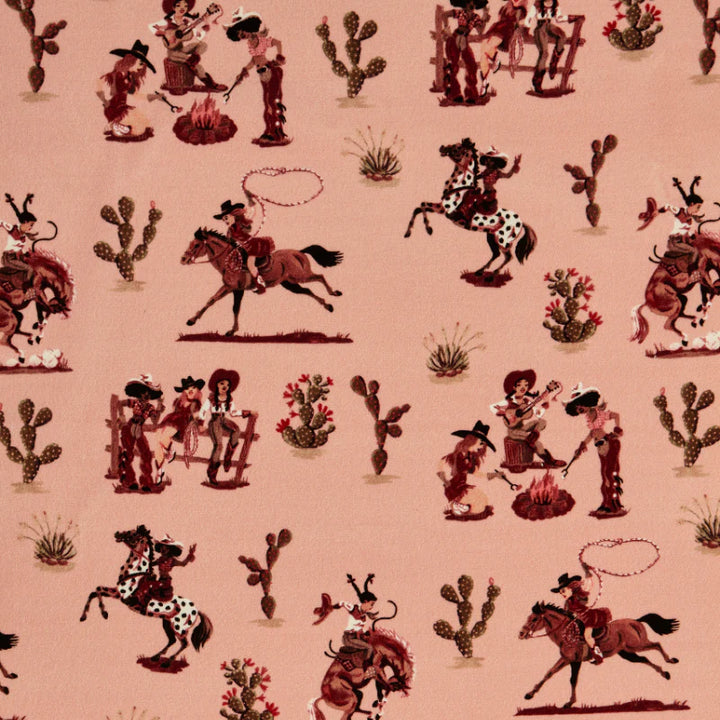 poodle-and-blonde-fabric-linen-cliftonville-cowgirls-pink-based-retro-kitsch-pattern-cowgirls-riding-western-rodeo-pattern-cabin-look-motel-pink