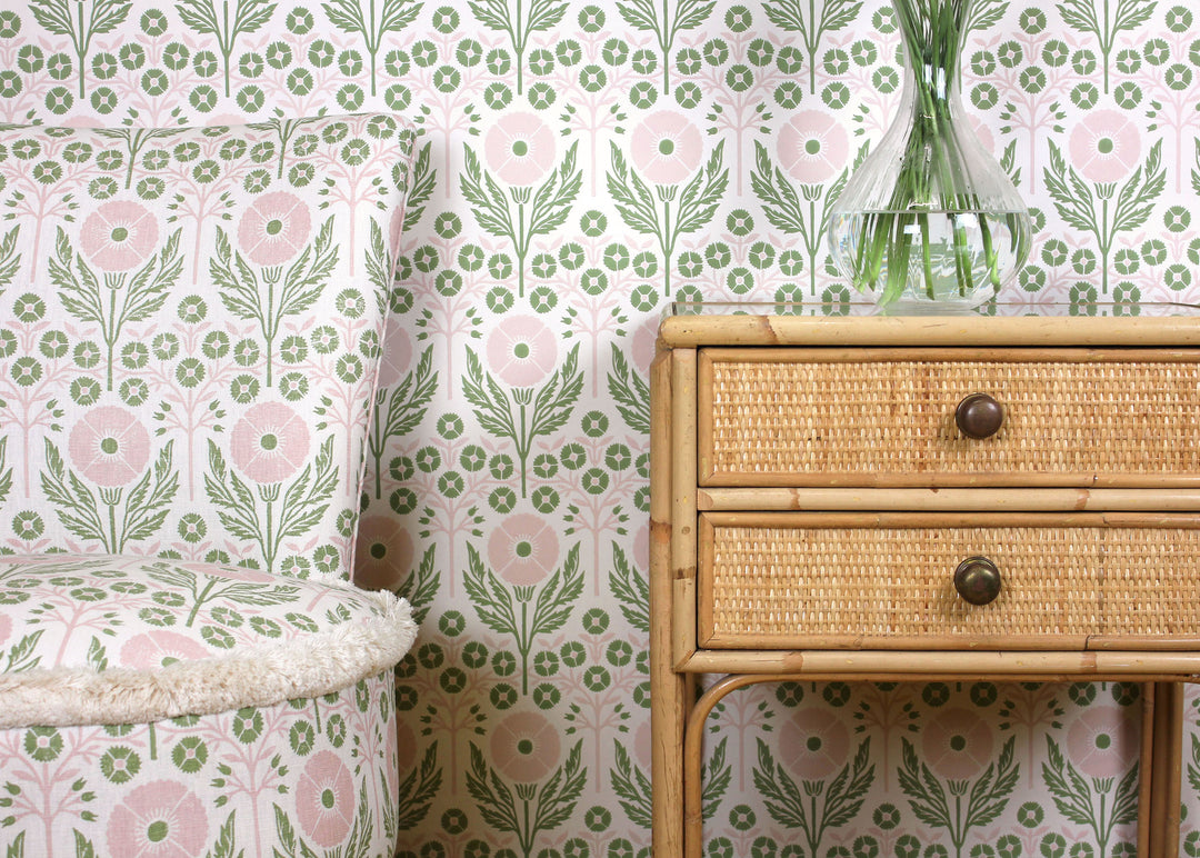ellen-merchant-fresca-wallpaper-poppy-green-pink-floral-wallpaper-block-printed-british-designer-textiles-rattan-bedside-table-upholstered-chair