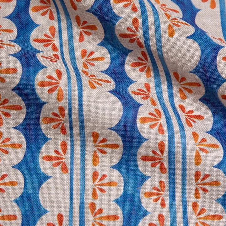 Bethie-Tricks-Textiles-pool-party-cream-scalloped-edge-stripes-orange-posy-print-against-indigo-blue-base