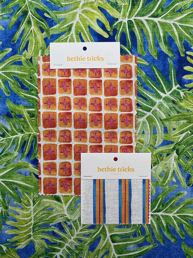 Bethie-Tricks-textiles-sun-bloc-print-fabric-orange-squares-small-fuschia-flower-inside-bloc-print-check-pattern