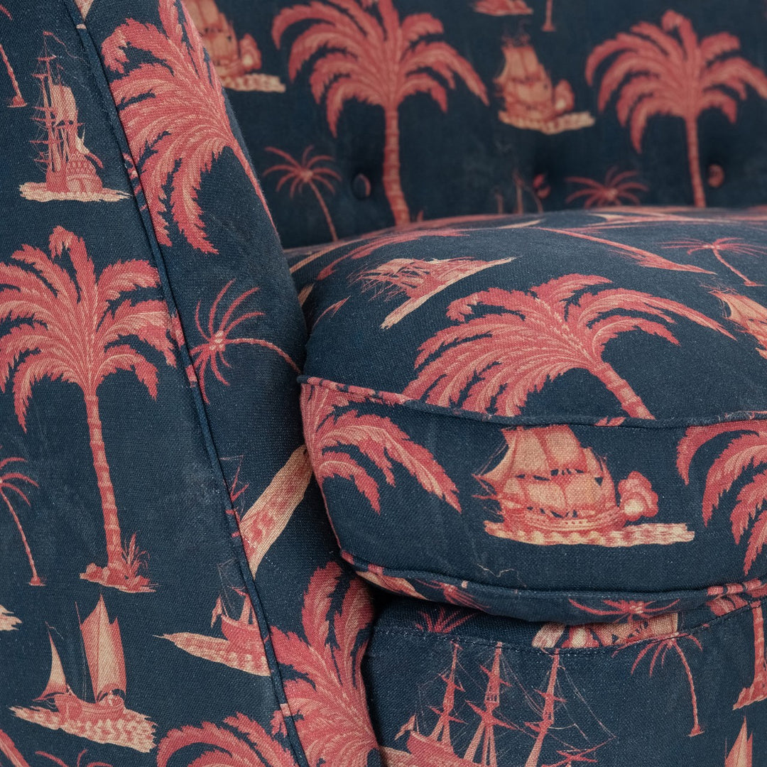 Mind-The-Gap-Venice-Tub-style-curved-sofa-couch-Aegean-linen-red-paln-print-navy-background-ships-trees-buttoned-back-exotic-print-metal-legs-hand-made