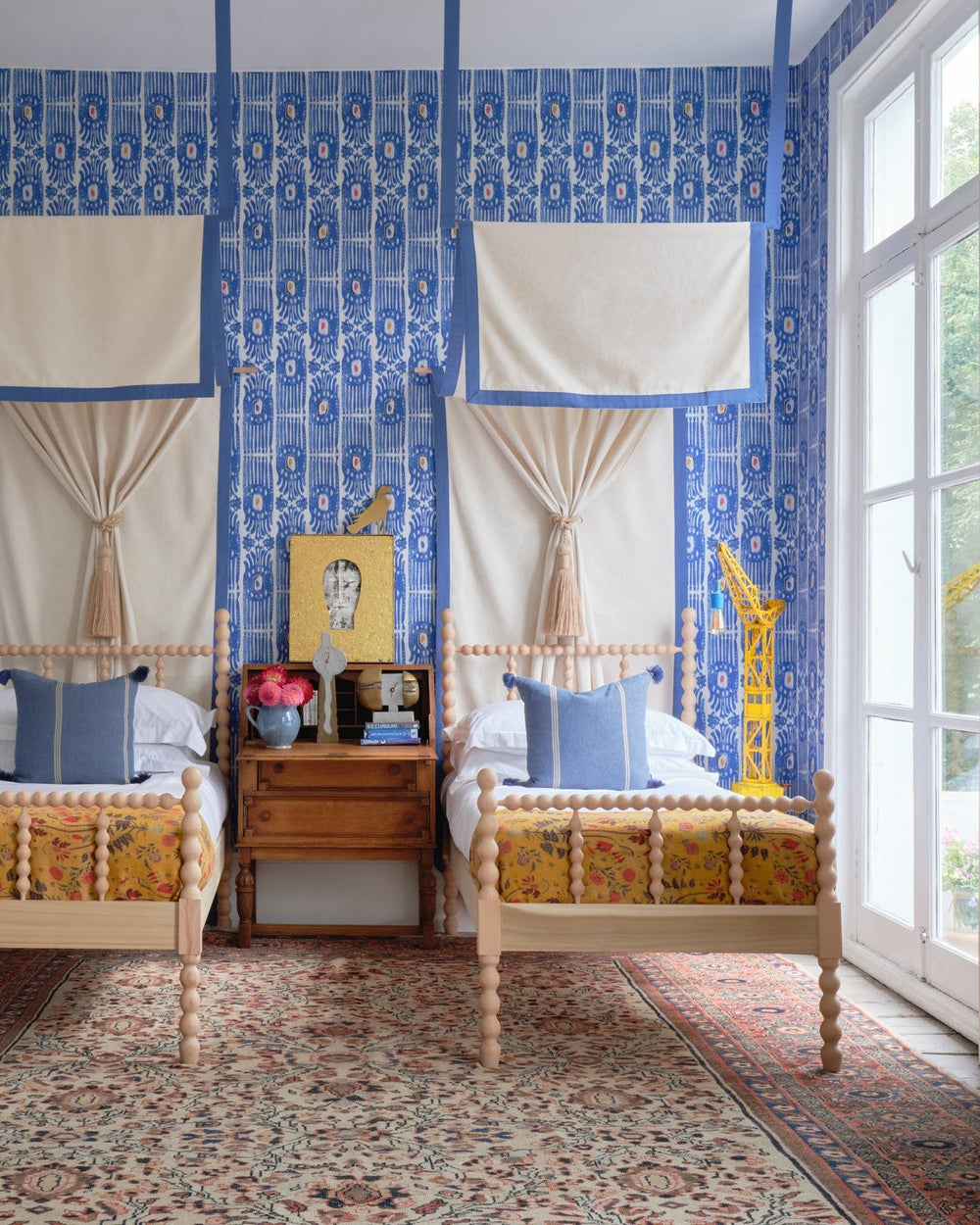 ikat-carnival-blue-wallpaper-minnie-kemp-mindthegap-collaboration-childrens-bedroom-two-single-beds-with-canopes