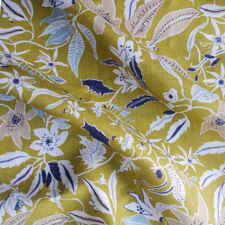 Lowri-textile-jasmine-and-clematis-linen-yellow-fabric-linen-printed-british-floral-vines-flowers-purple-white-yellow-vines-trailing-pattern-fabric-mustard