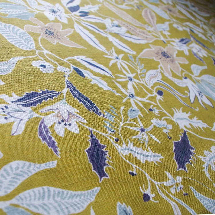 Lowri-textile-jasmine-and-clematis-linen-yellow-fabric-linen-printed-british-floral-vines-flowers-purple-white-yellow-vines-trailing-pattern-fabric-mustard