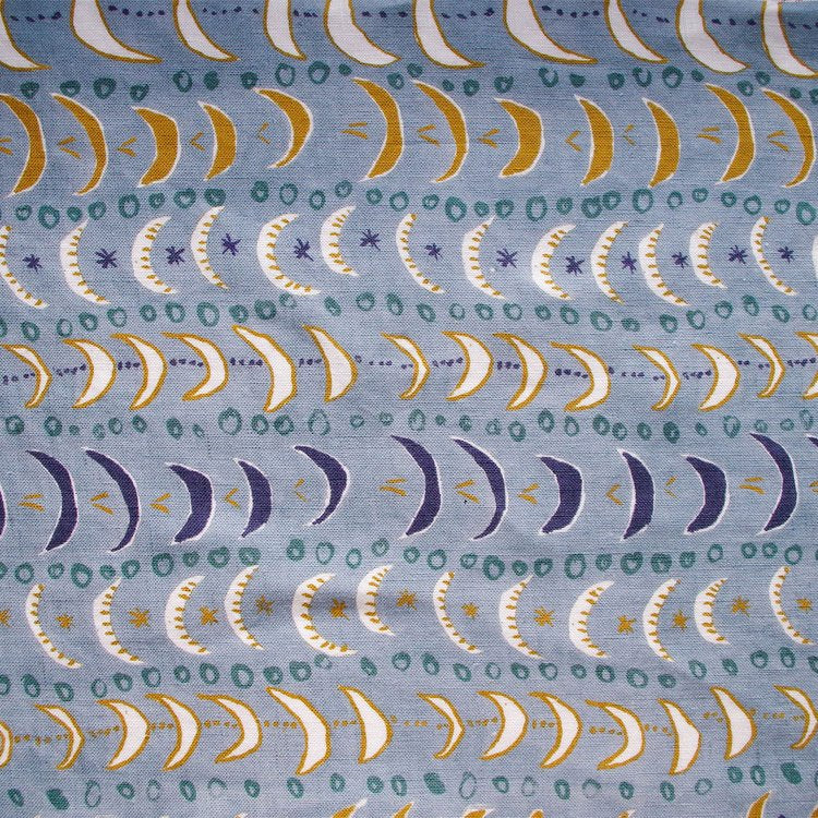 Lowri-textiles-mini-moons-linen-blue-crescent-moon-print-repeat-starts-ditsy-blue-navy-white-ochre-green-sweet-pattern-kids-childrens-textiles-fabric-british-printed