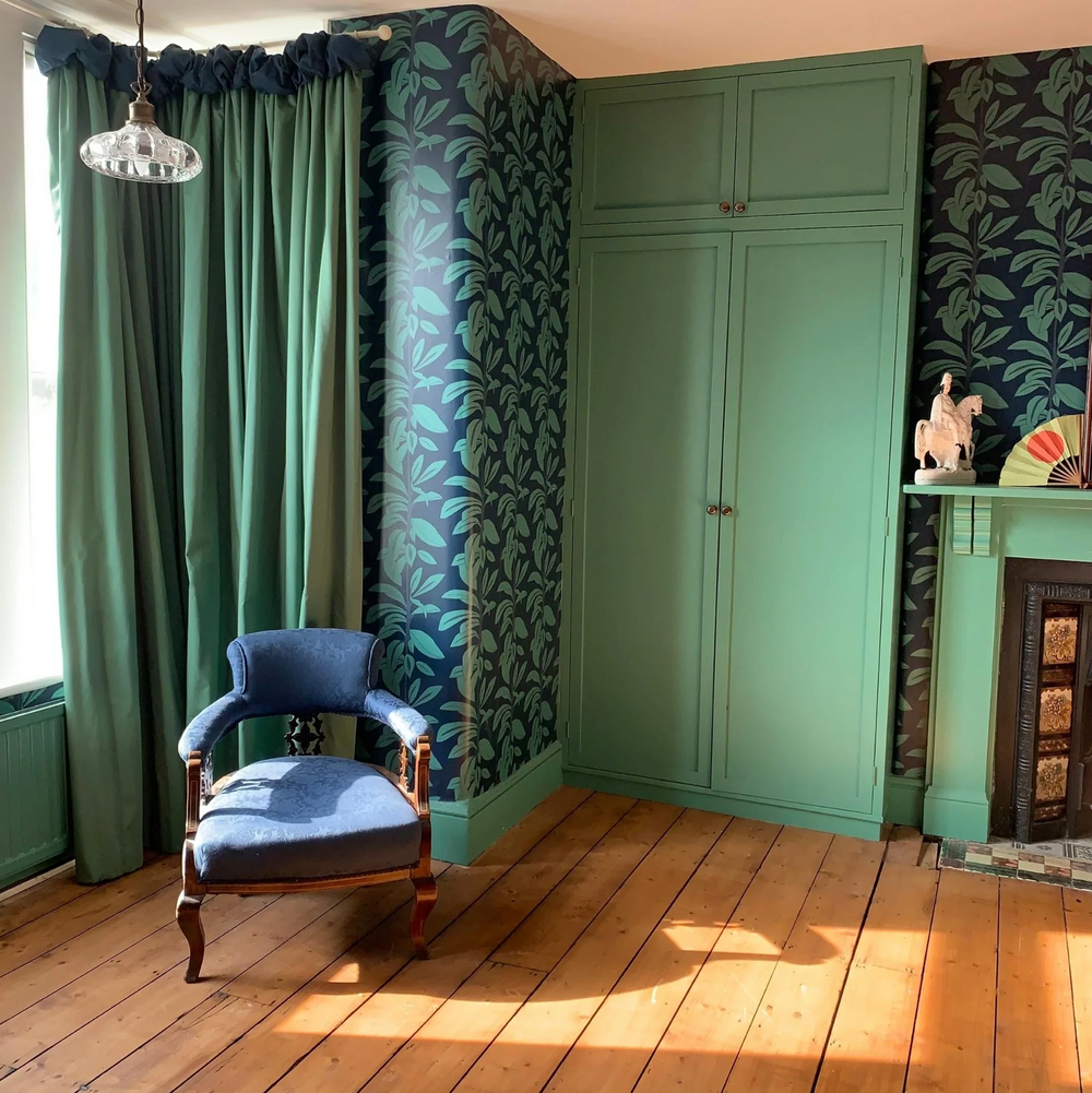 Annika-reed-studio-rubber-plant-wallpaper-block-printed-green-blue-wallcovering-print-design-the-design-yard-roomset-victorian-modern-livingroom