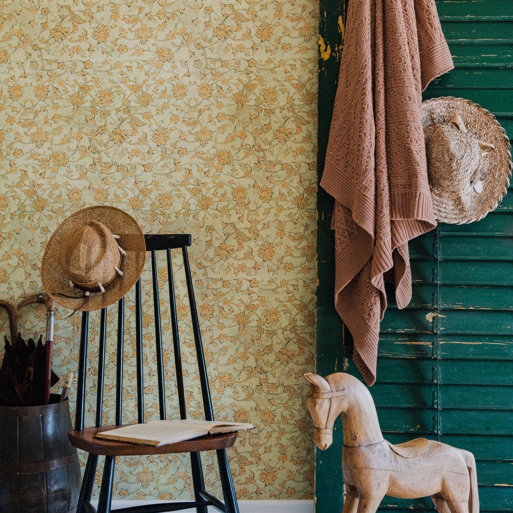 yellow-orange-floral-wallpaper-green-painted-shutter-rocking-horse-black-wooden-chair-mind-the-gap-backyard-flowering-transylvanian-roots-collection-complementary-blue-orange-wallpaper-floral-maximalist-statement-interior