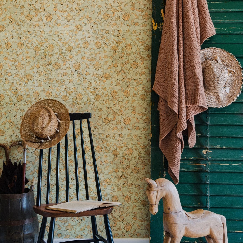 yellow-orange-floral-wallpaper-green-painted-shutter-rocking-horse-black-wooden-chair-mind-the-gap-backyard-flowering-seacrest-wallpaper-transylvanian-roots-collection-complementary-yellow-orange-beige-floral-maximalist-statement-interior