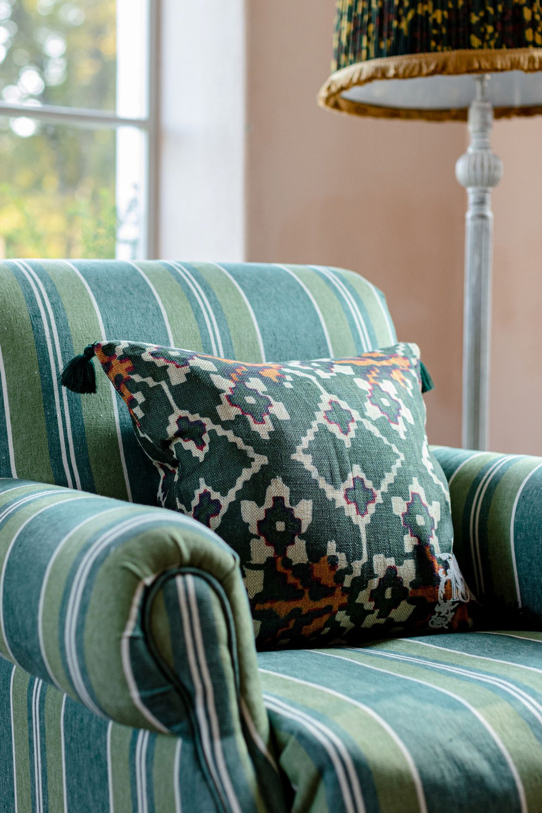 mind-the-gap-zold-linen-cushion-green-orange-cream-tassel-pattern-cushion-armchair-stripe
